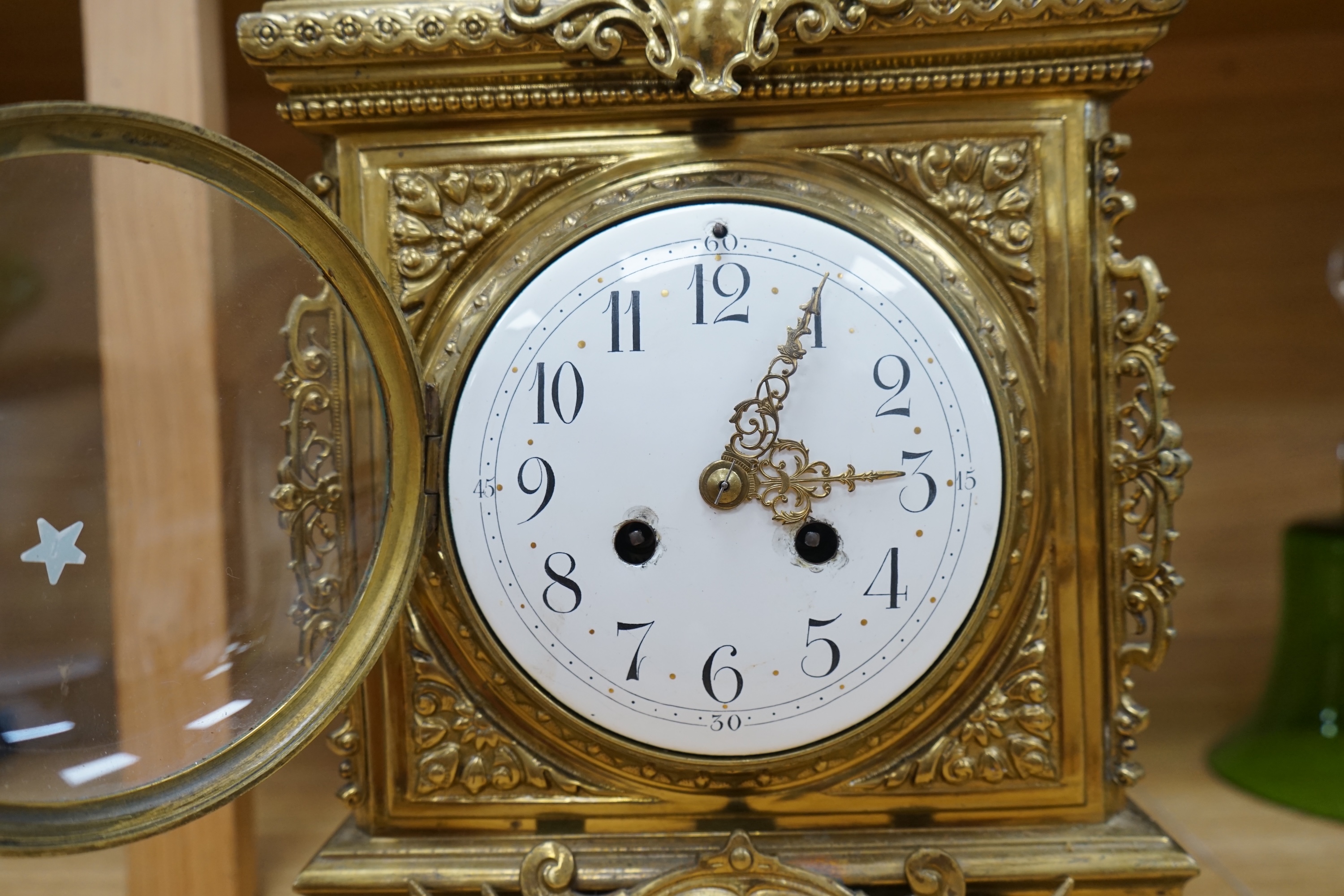 A Louis XVI style ormolu mantel clock with enamel dial, key and pendulum, 42cm. Condition - fair to good